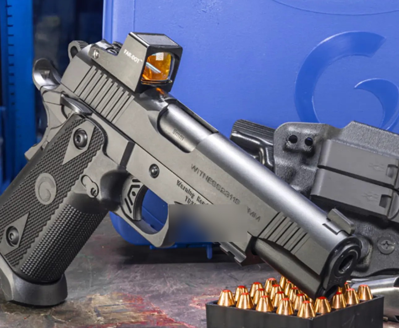 Girsan Witness 2311 Match X 9mm double-stack pistol with a red dot optic, resting on a tray of ammunition in front of its blue case