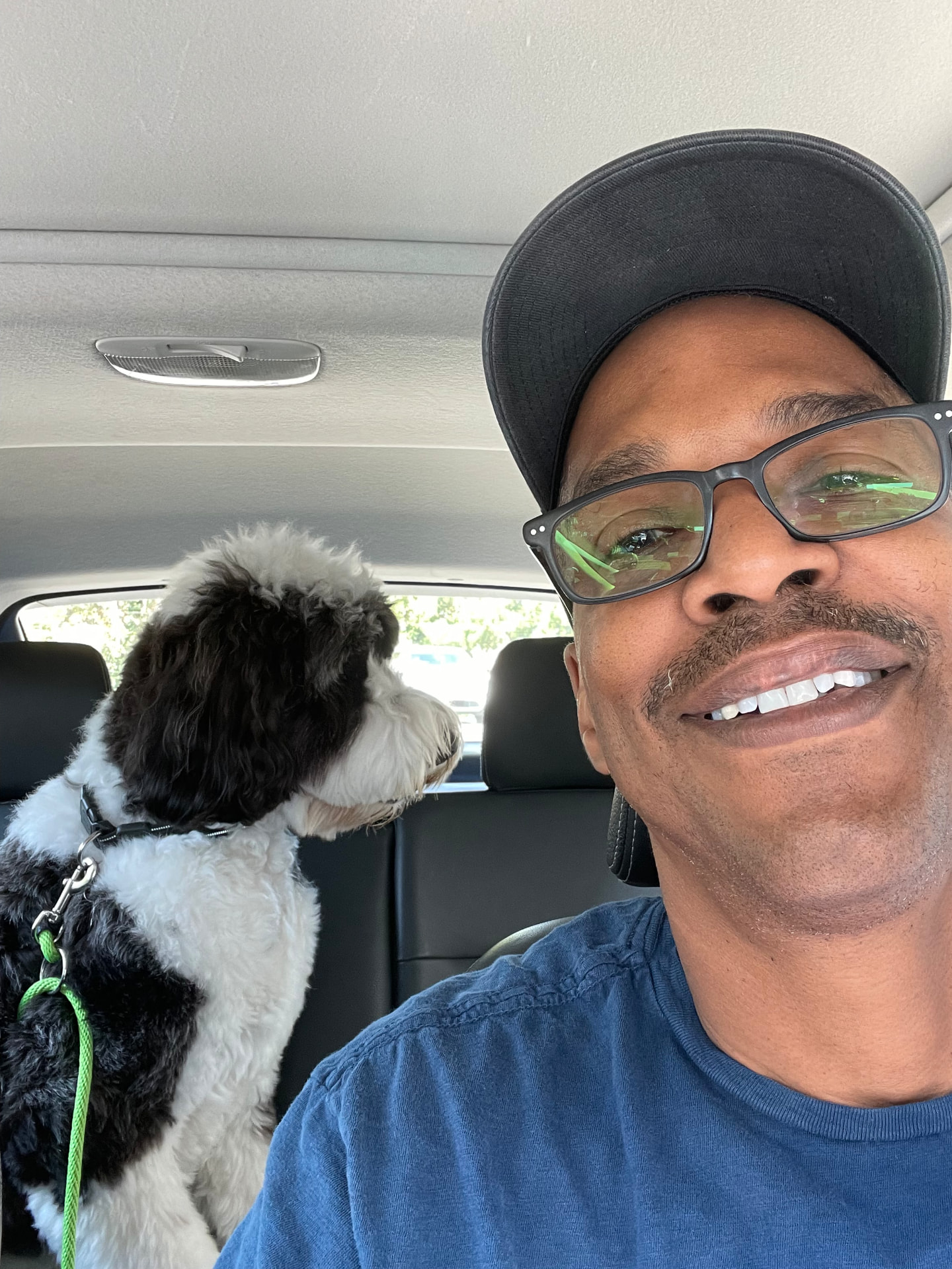 The instructor with his dog in the car